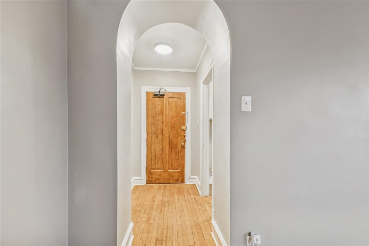 3017 East 78th Street, Unit 4B Chicago, IL 60649 - Photo 11 of 15 an empty room with wooden floor and a window
