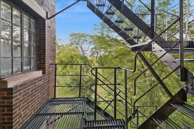 a view of a balcony with wooden floor and a bench
