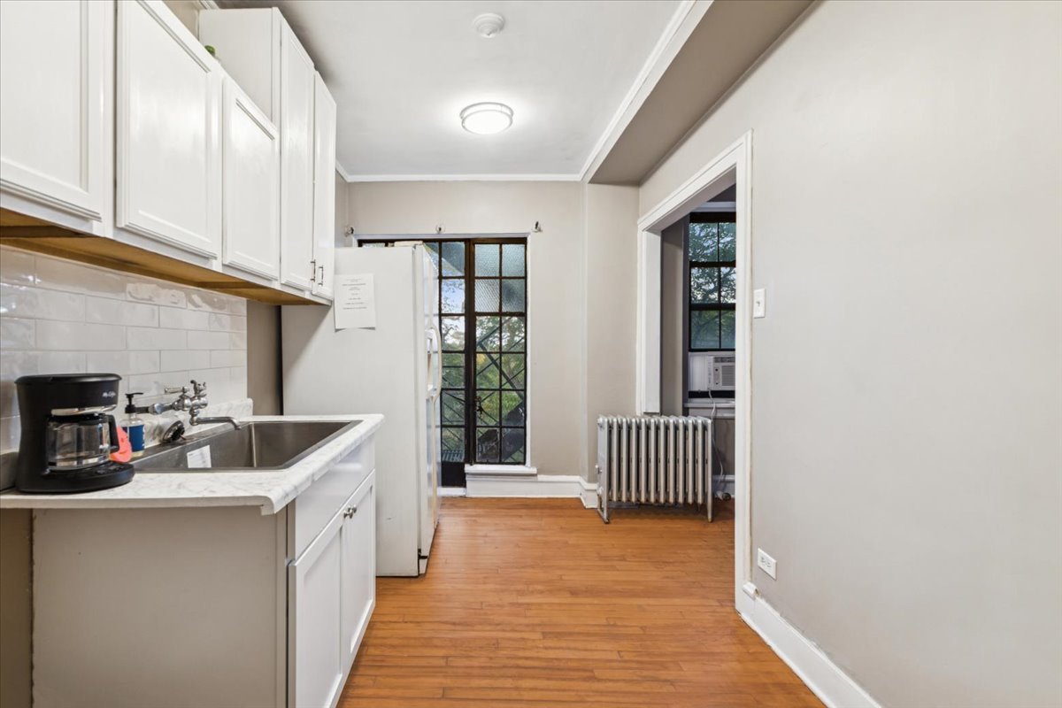 3017 East 78th Street, Unit 4B Chicago, IL 60649 - Photo 5 of 15 a kitchen with furniture and a window