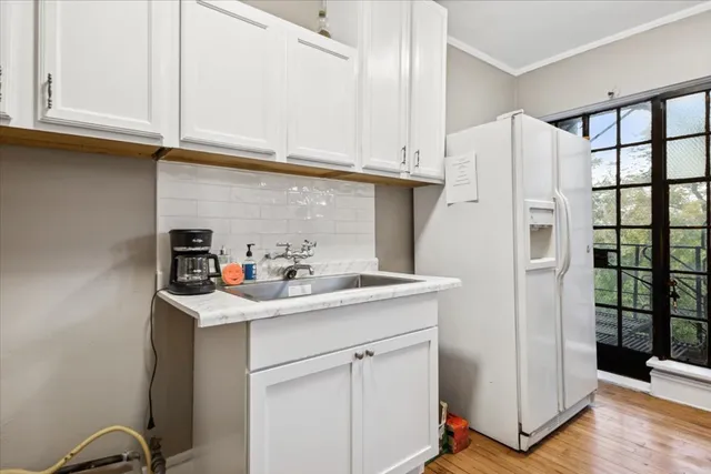 a kitchen with stainless steel appliances granite countertop a sink and a refrigerator