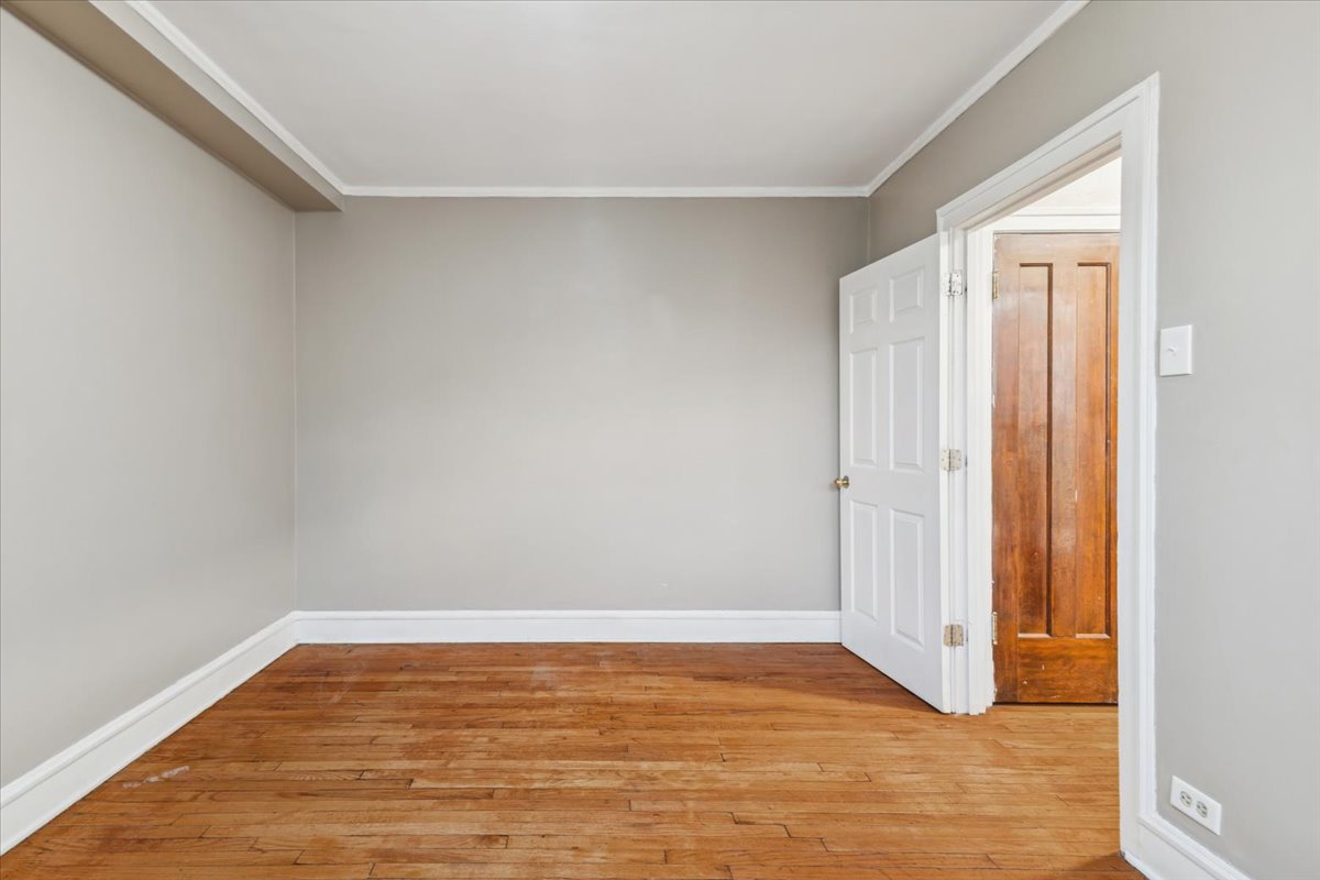 3017 East 78th Street, Unit 4B Chicago, IL 60649 - Photo 8 of 15 a view of room with wooden floor