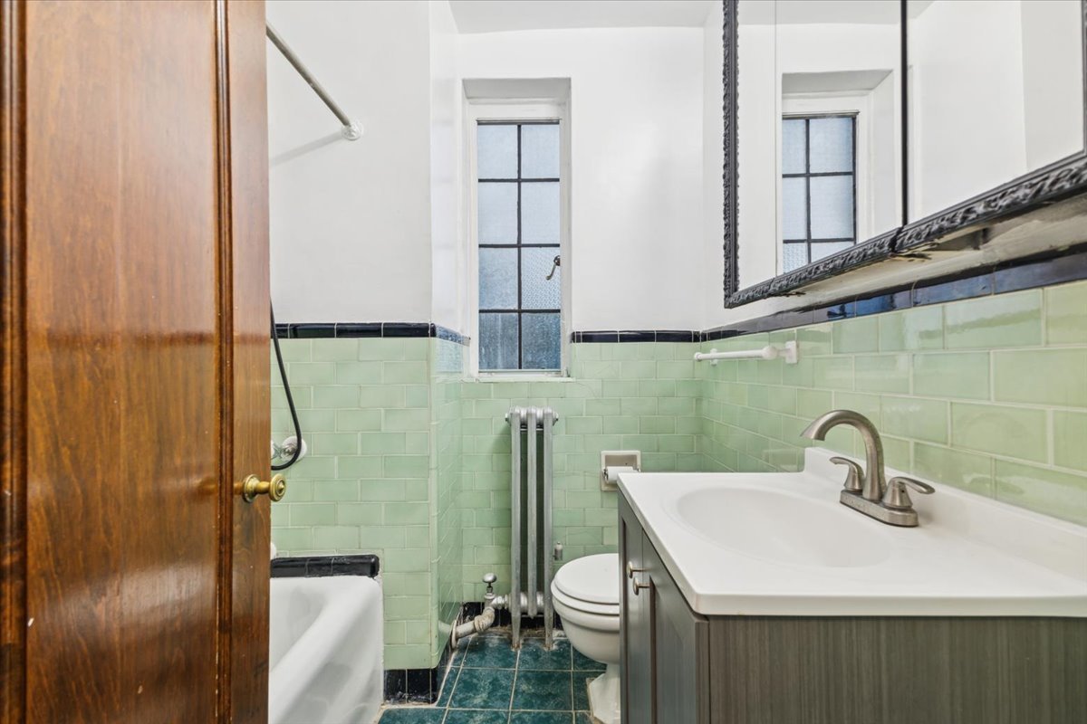 3017 East 78th Street, Unit 4B Chicago, IL 60649 - Photo 10 of 15 a bathroom with a sink and mirror