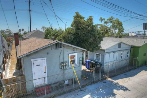 a backyard of a house with table and chairs