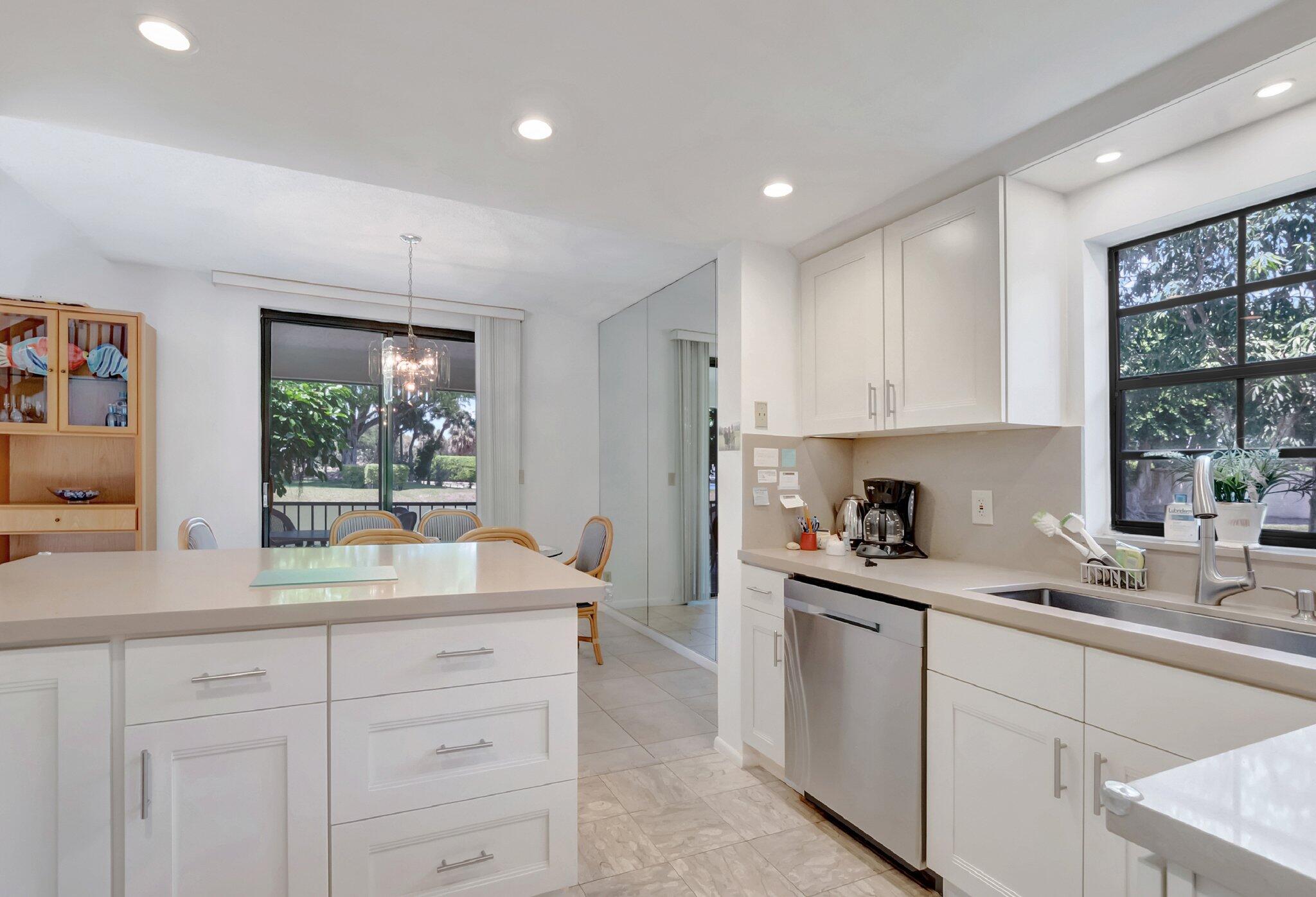 7950 La Mirada Drive Boca Raton, FL 33433 - Photo 12 of 42 a kitchen with a sink window and cabinets