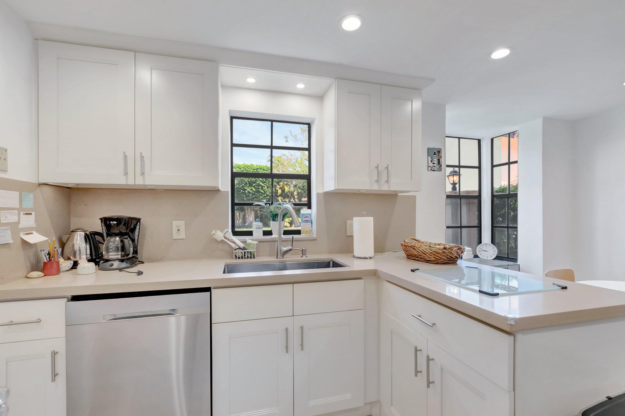 7950 La Mirada Drive Boca Raton, FL 33433 - Photo 13 of 42 a kitchen with sink cabinets and window