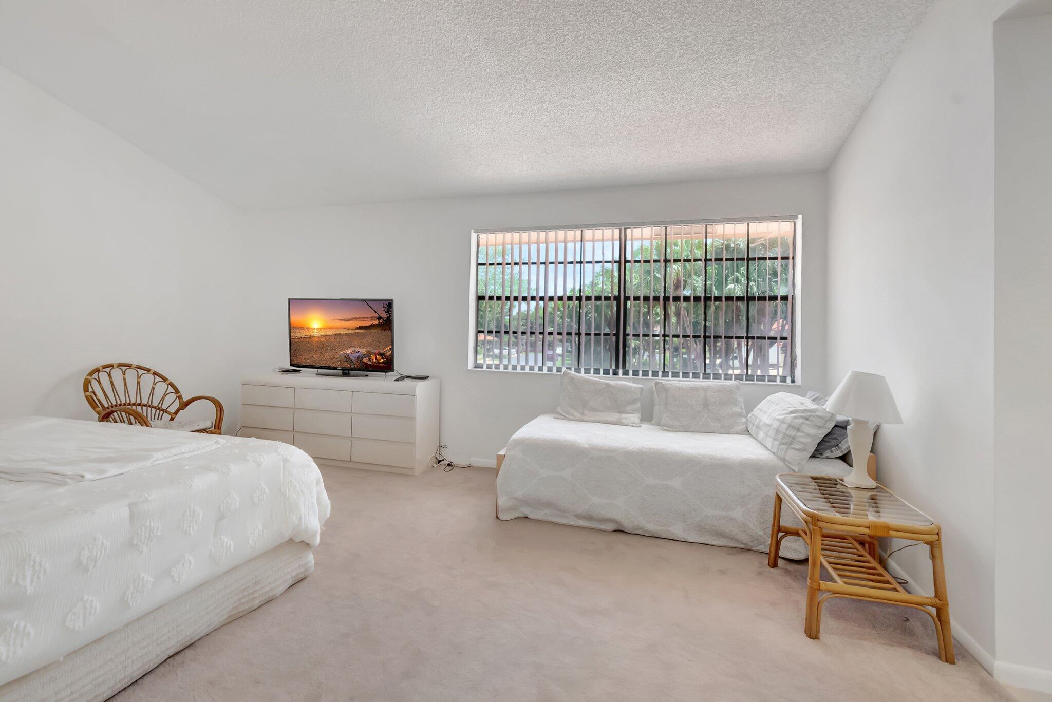 7950 La Mirada Drive Boca Raton, FL 33433 - Photo 18 of 42 a bedroom with a bed and a tv on dresser