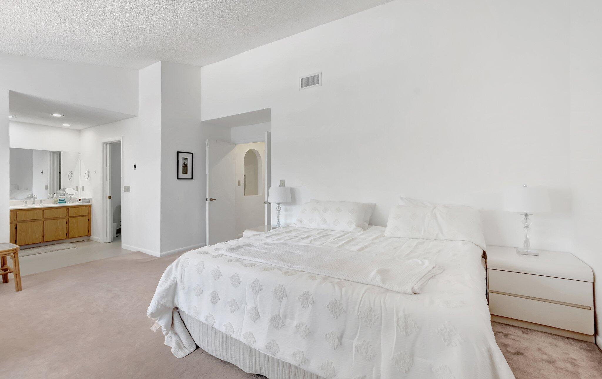 7950 La Mirada Drive Boca Raton, FL 33433 - Photo 19 of 42 a large white bed in a white room