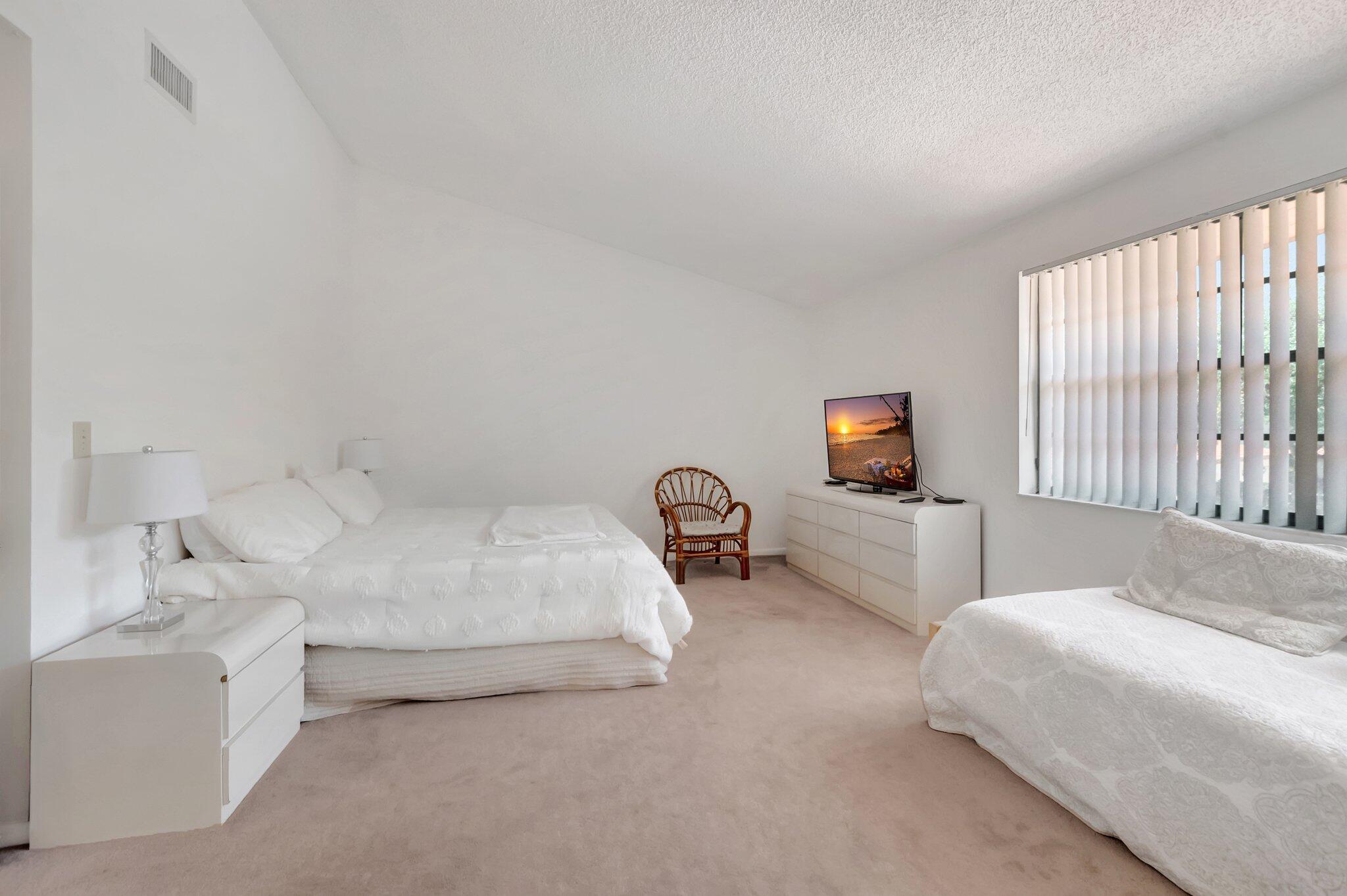 7950 La Mirada Drive Boca Raton, FL 33433 - Photo 20 of 42 a bedroom with a bed and a couch