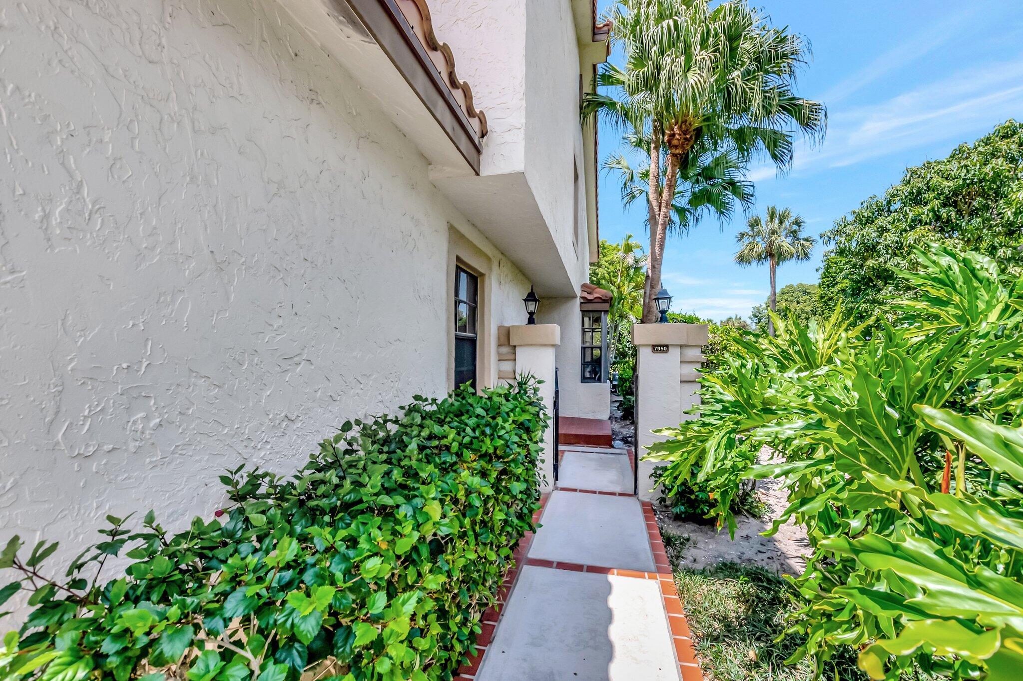 7950 La Mirada Drive Boca Raton, FL 33433 - Photo 2 of 42 a view of a pathway with a flower