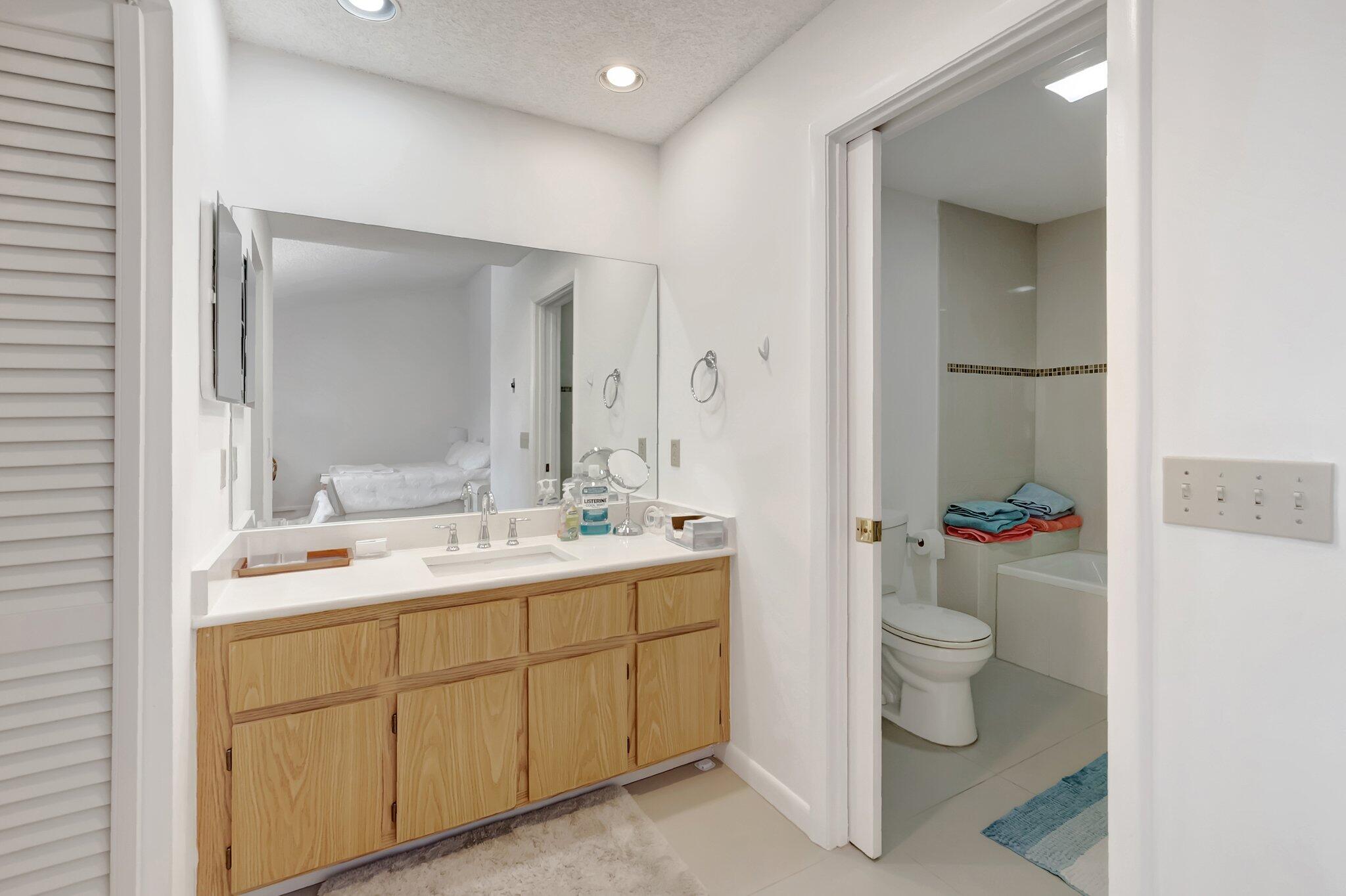 7950 La Mirada Drive Boca Raton, FL 33433 - Photo 21 of 42 a spacious bathroom with a toilet sink and mirror