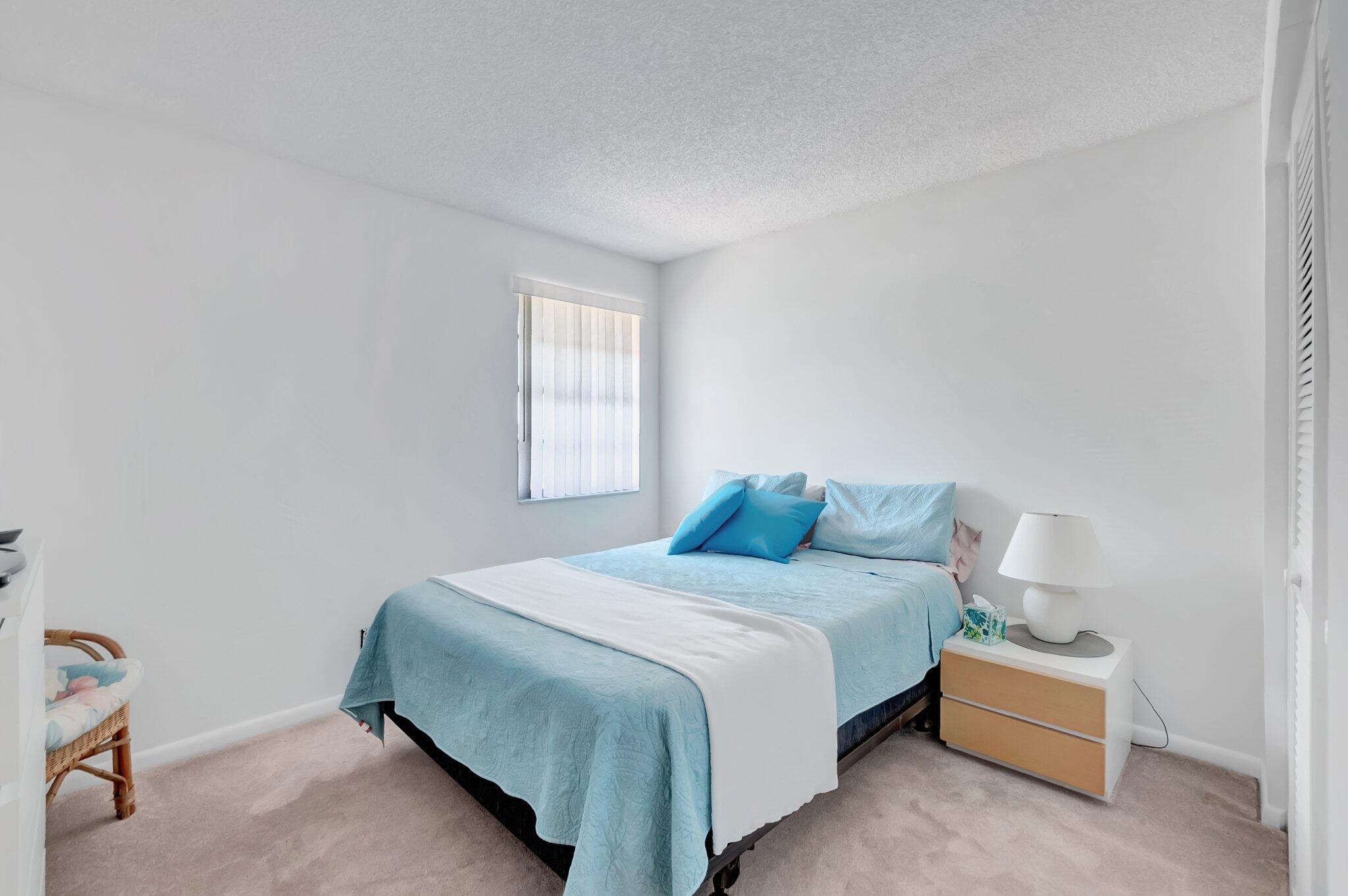 7950 La Mirada Drive Boca Raton, FL 33433 - Photo 24 of 42 a bedroom with a bed and a window