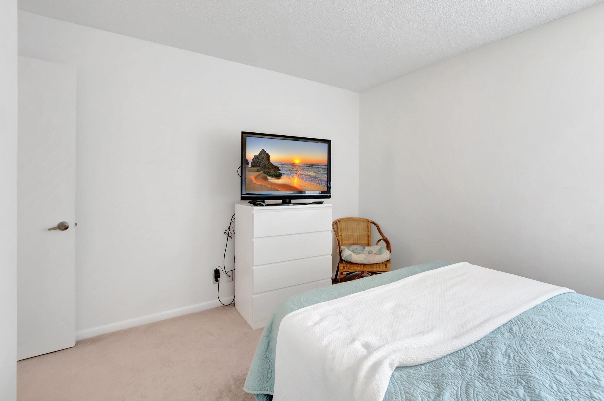 7950 La Mirada Drive Boca Raton, FL 33433 - Photo 25 of 42 a bedroom with a bed and a flat screen tv