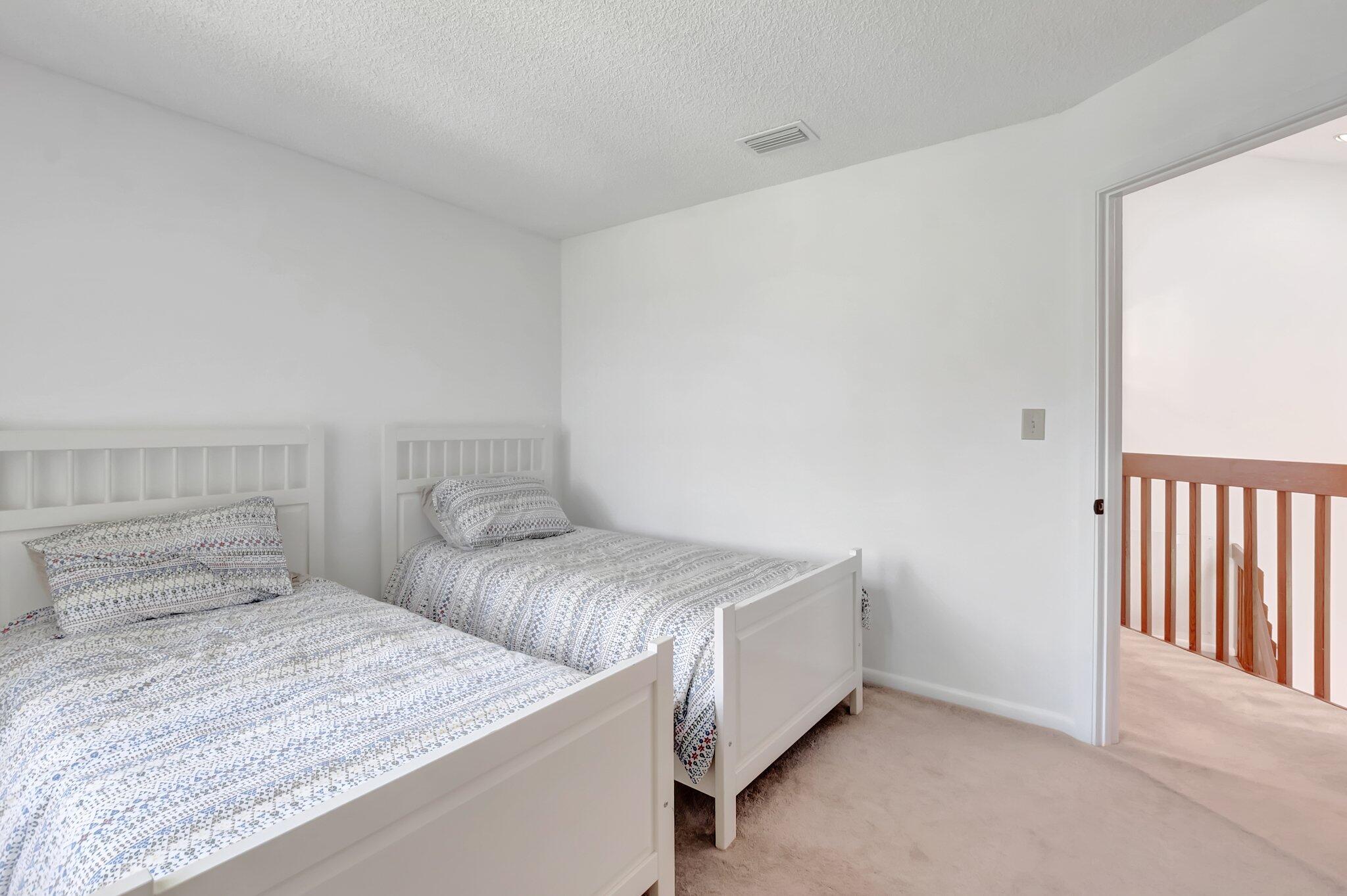 7950 La Mirada Drive Boca Raton, FL 33433 - Photo 29 of 42 a bedroom with two beds and a night stand