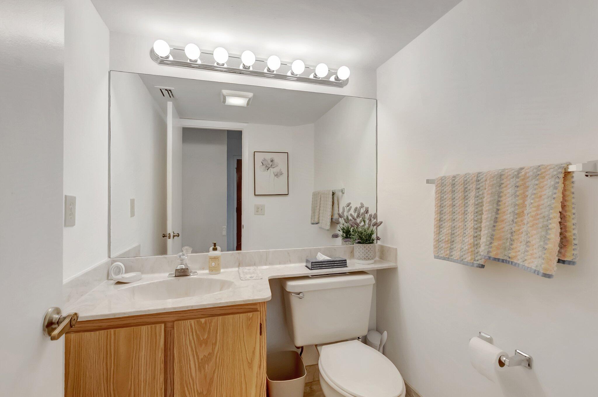 7950 La Mirada Drive Boca Raton, FL 33433 - Photo 30 of 42 a bathroom with a granite countertop sink toilet and mirror