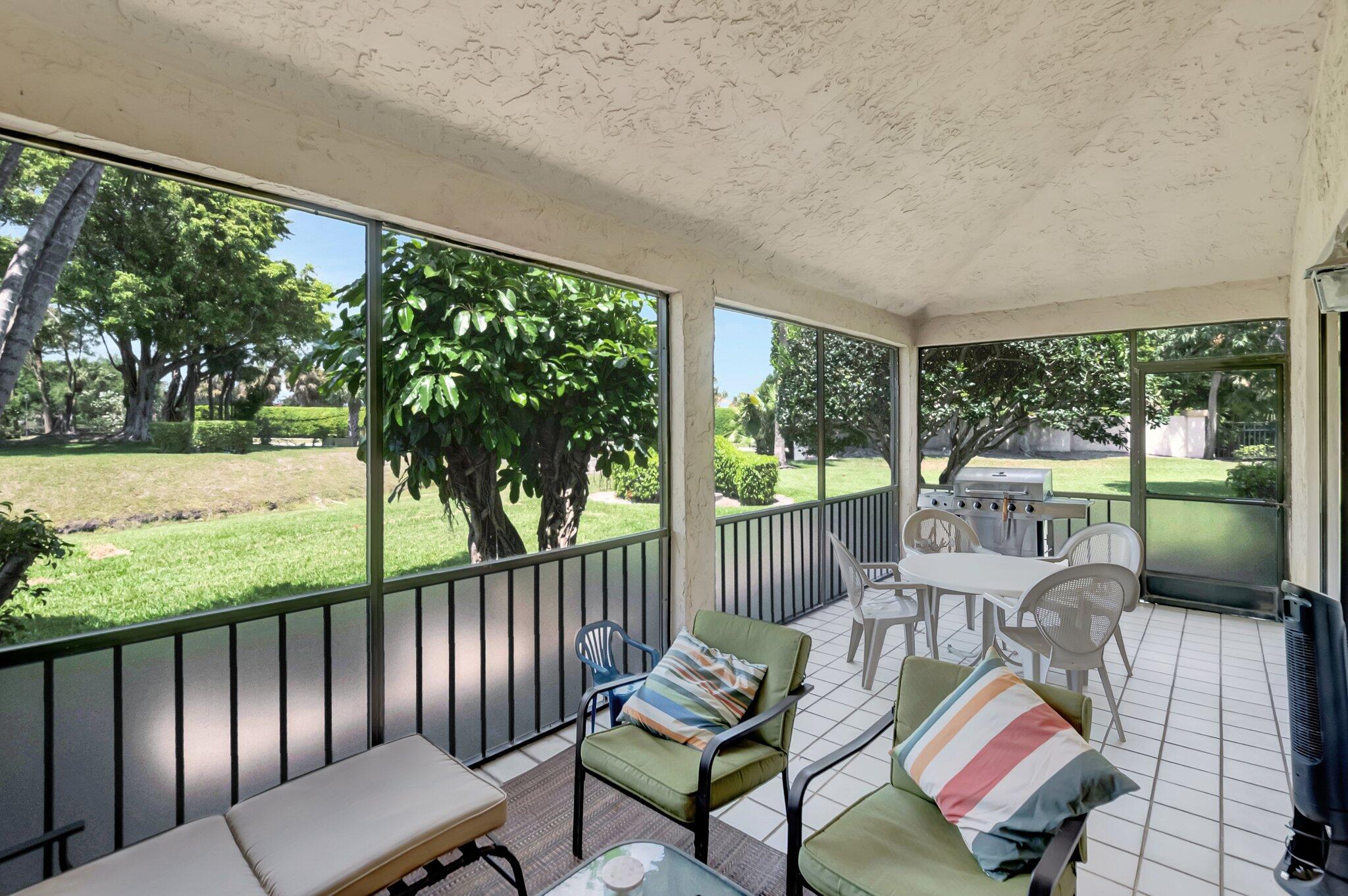 7950 La Mirada Drive Boca Raton, FL 33433 - Photo 33 of 42 a balcony with wooden floor and outdoor seating