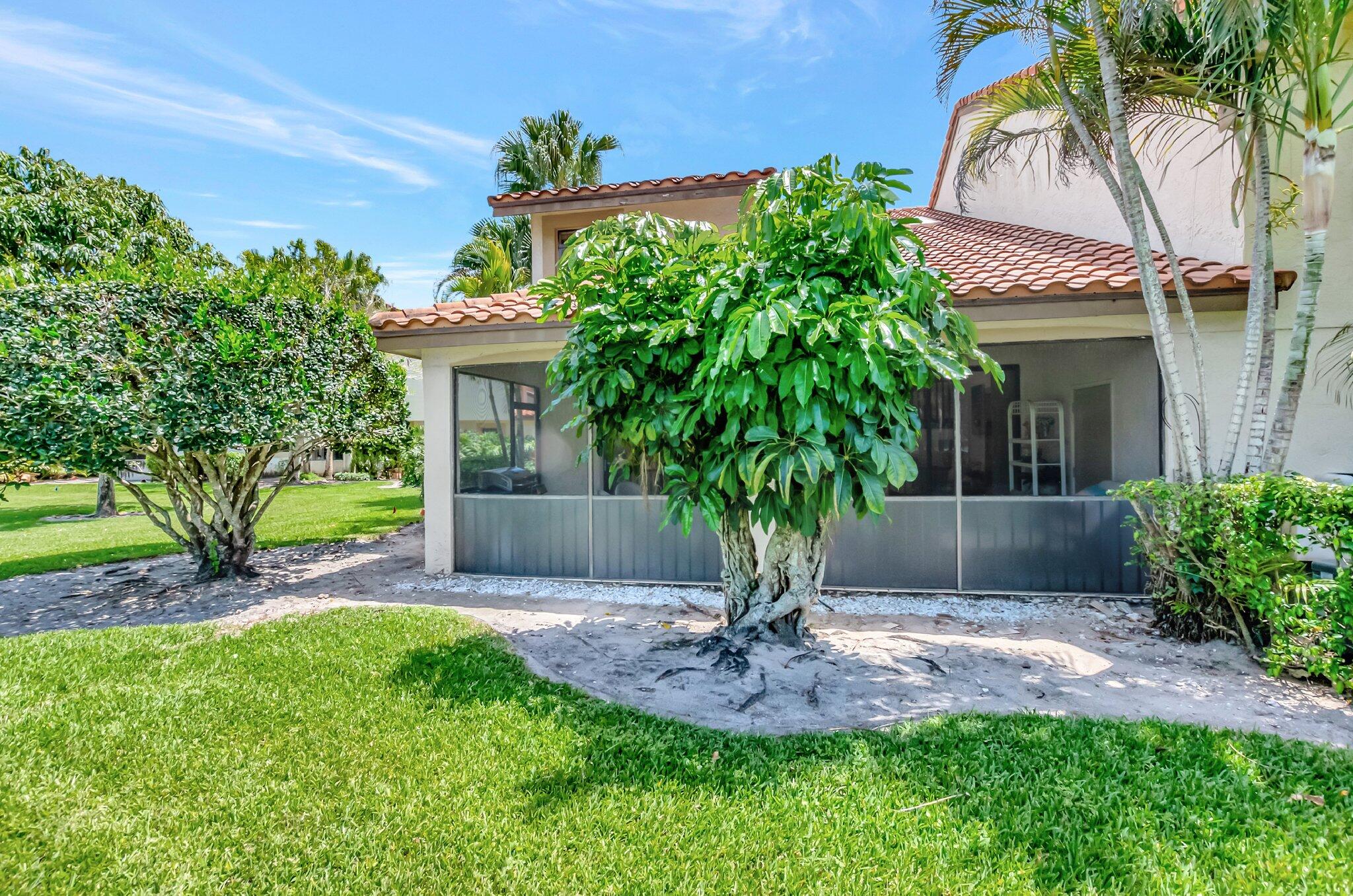 7950 La Mirada Drive Boca Raton, FL 33433 - Photo 37 of 42 a front view of a house with a yard and potted plants