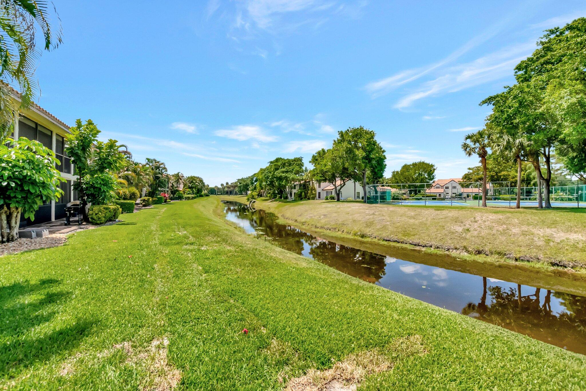 7950 La Mirada Drive Boca Raton, FL 33433 - Photo 40 of 42 a view of a lake with a yard