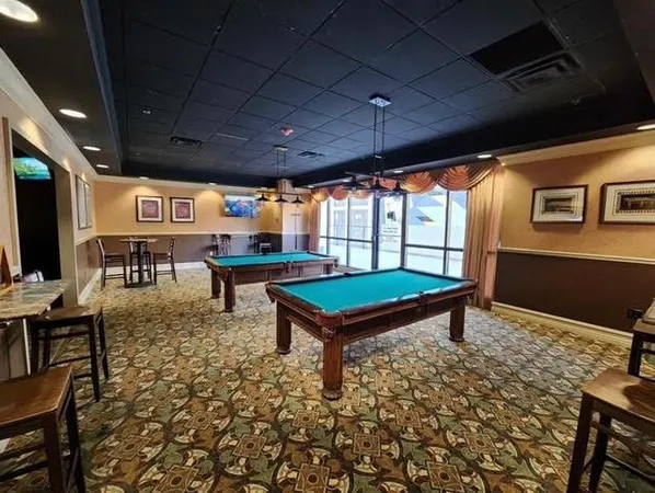 a living room with furniture a flat screen tv and a table