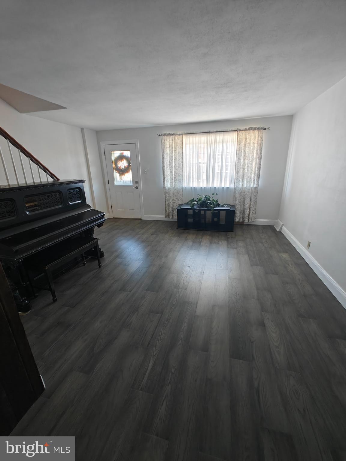 6448 Akron Street Philadelphia, PA 19149 - Photo 7 of 30 a view of an empty room with wooden floor and a window