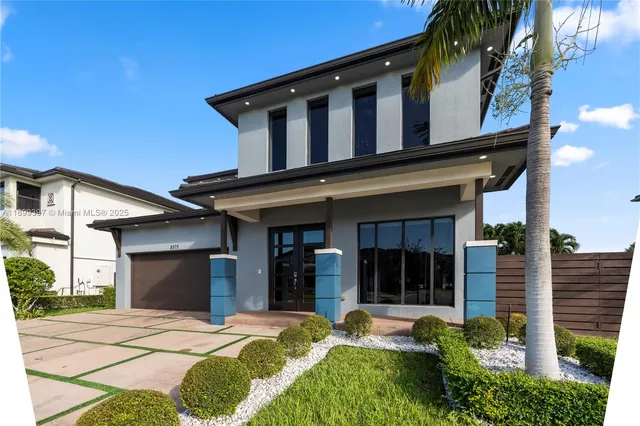 a front view of a house with a garden