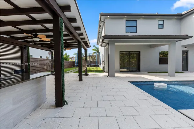 a view of a porch with furniture and a backyard