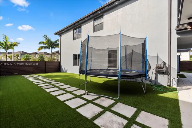 a view of a house with backyard swimming pool and sitting area