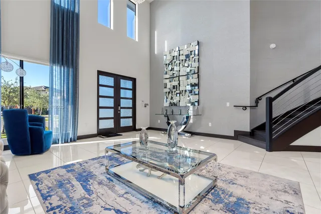a living room with furniture a rug and a chandelier