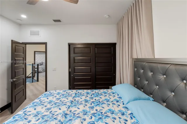 a bedroom with a bed and a chandelier