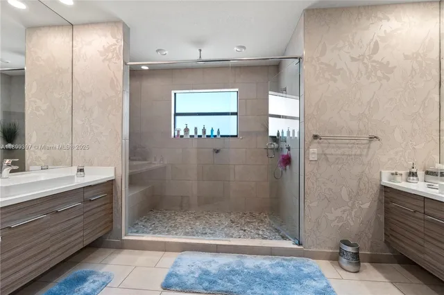 a bathroom with a shower sink and mirror