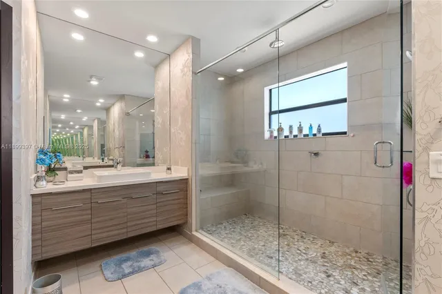 a bathroom with a tub sink and mirror