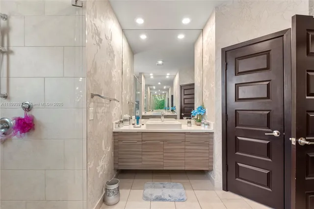 an aerial view of a house with a yard potted plants and large trees