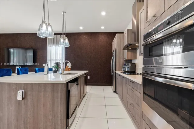 a kitchen with stainless steel appliances a sink and a refrigerator
