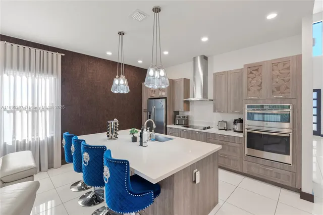 a kitchen with a dining table chairs and white cabinets