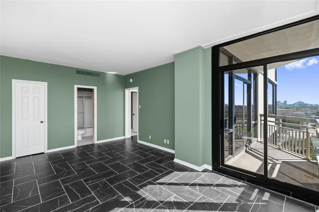 a bedroom with a bed and large windows