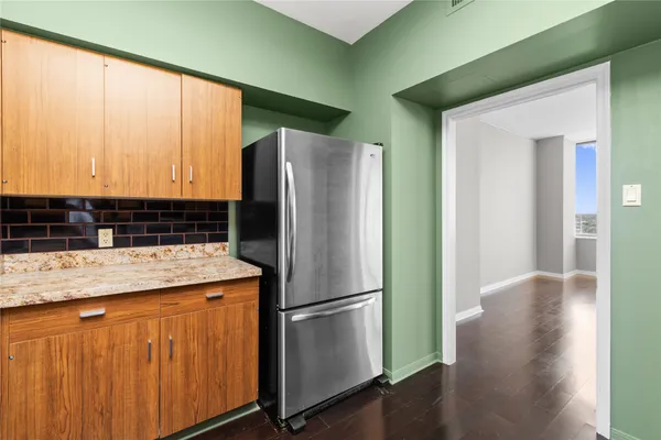 a kitchen with stainless steel appliances granite countertop a refrigerator and a sink