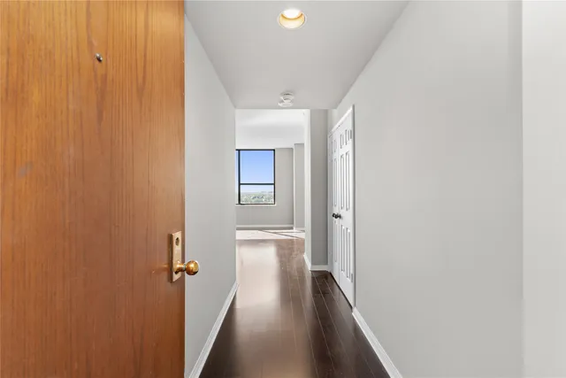 a view of a hallway with wooden floor