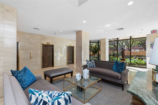 a living room with furniture and large window