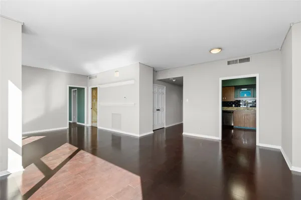 a view of a hallway with wooden floor and furniture