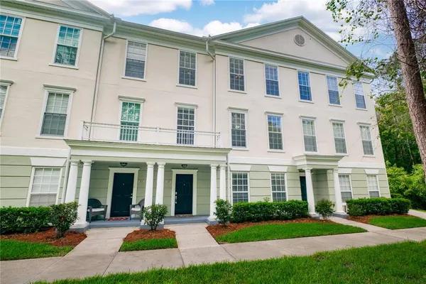 a front view of a brick house with a yard