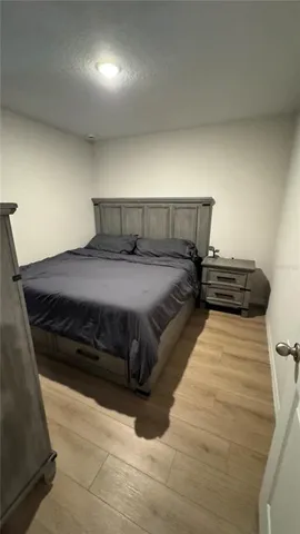 a bedroom with a bed and a night stand