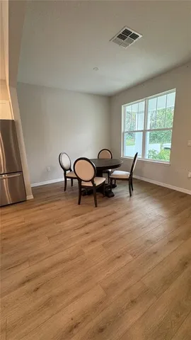 a view of a dining room with furniture window and wooden floor