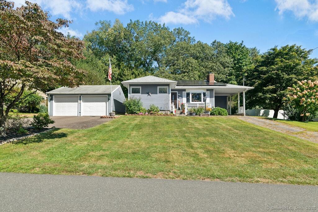a front view of a house with a yard and trees