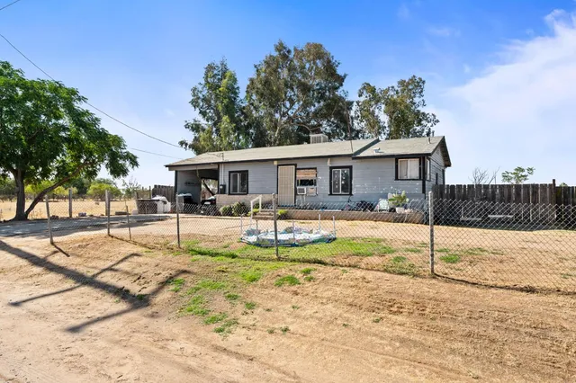 a view of a house with swimming pool and porch