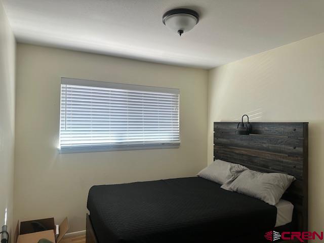 726 East 3rd Street Cortez, CO 81321 - Photo 14 of 20 a bedroom with a bed and a window