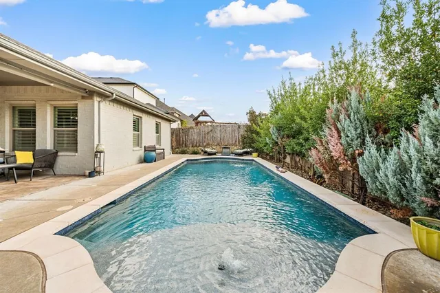 a view of a backyard with plants and a patio