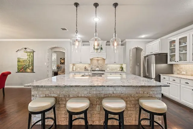 a dining table with chairs and kitchen island