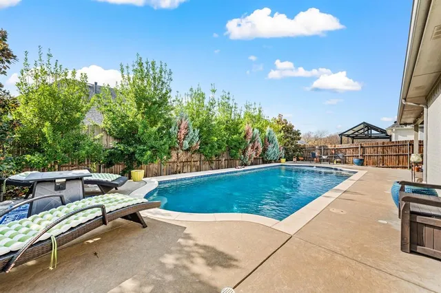 a view of swimming pool with seating space