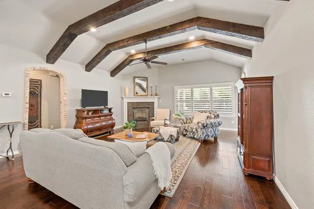 a living room with furniture fireplace and flat screen tv