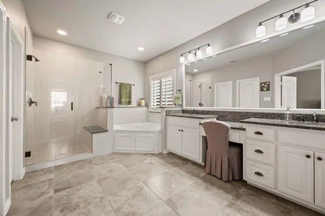 a large bathroom with a large mirror vanity and shower