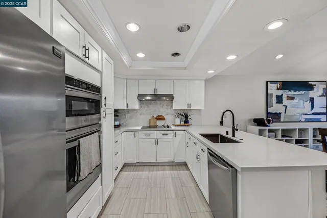 a kitchen with stainless steel appliances granite countertop a sink stove oven and refrigerator